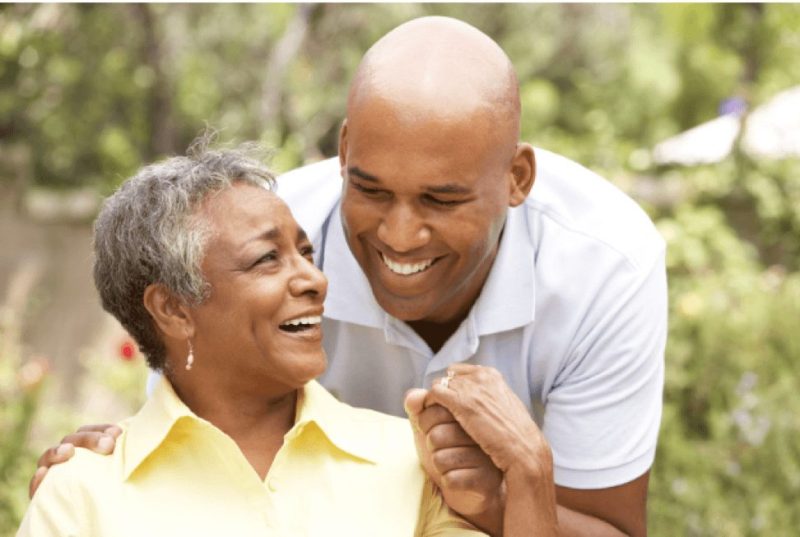 Mother and son holding hands and smiling outdoors in Maryland