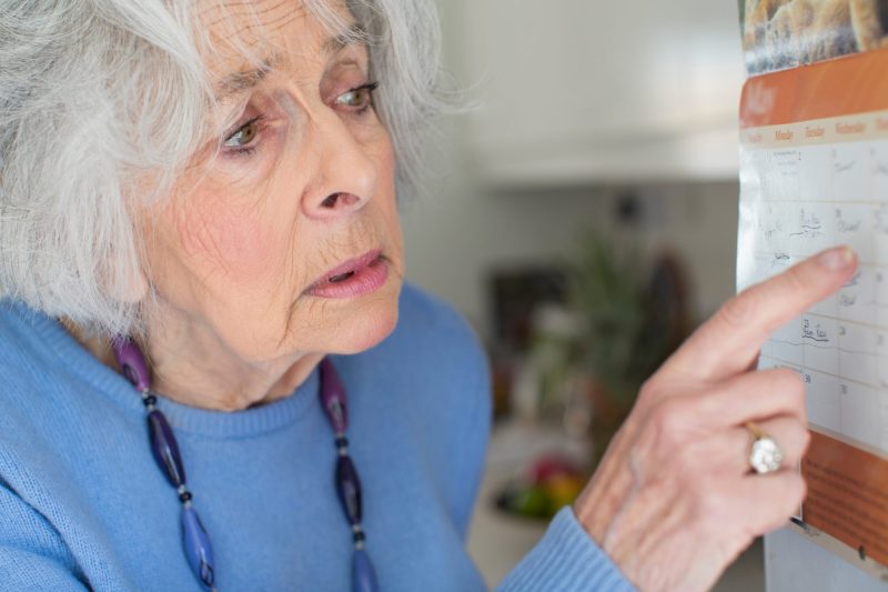 The old lady checking the date on calendar