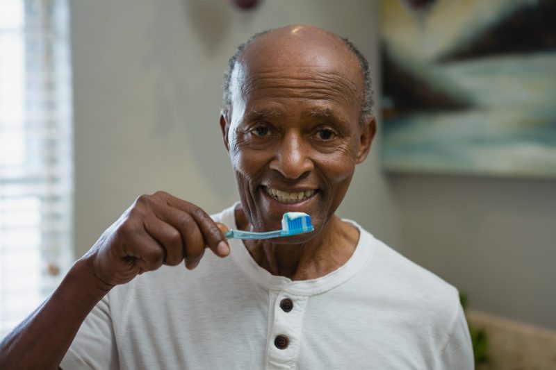 The older man posing with tooth brush at Rockville, MD