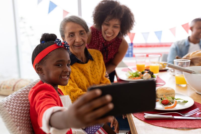 Family taking photo at dinner table in Maryland