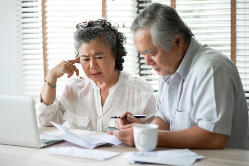 The two older people discussing with some documents