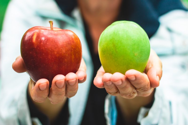 Nurse holding an apple in each hand