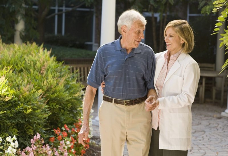 Doctor walking with an elderly man in Rockville, MD