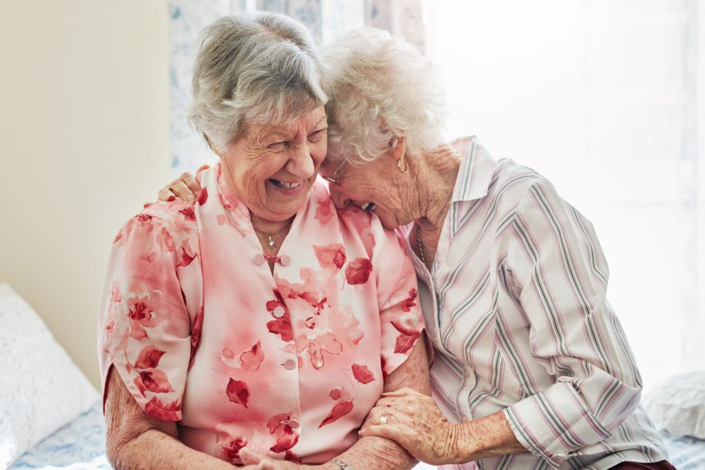 Two senior women laughing and enjoying one another’s company