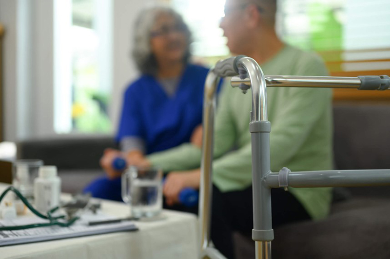 Elderly man receiving in-home care assistance in Rockville, MD with a walker in the foreground