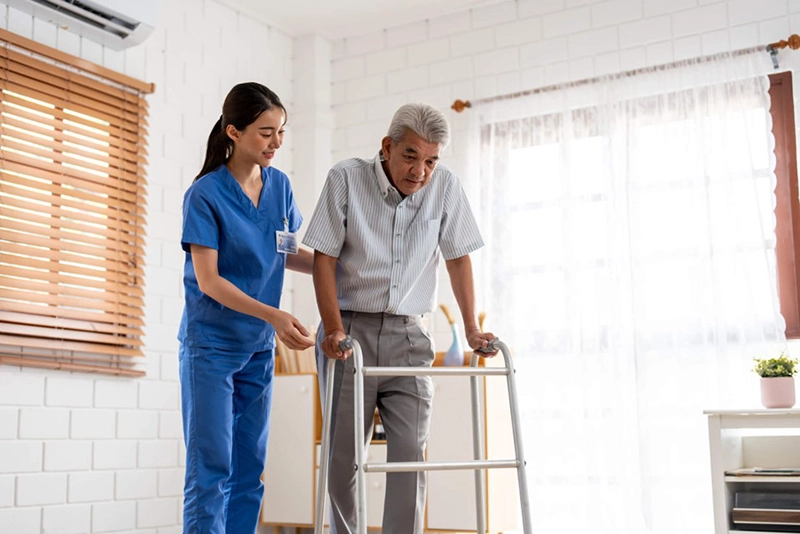 A caregiver helping a senior with mobility assistance in Washington, DC